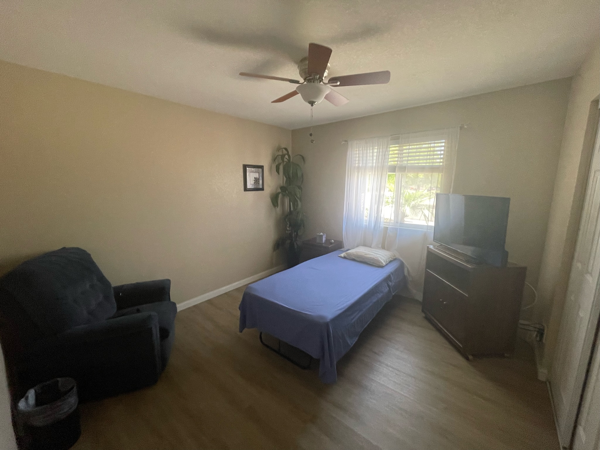 Private resident room with a bed and chair