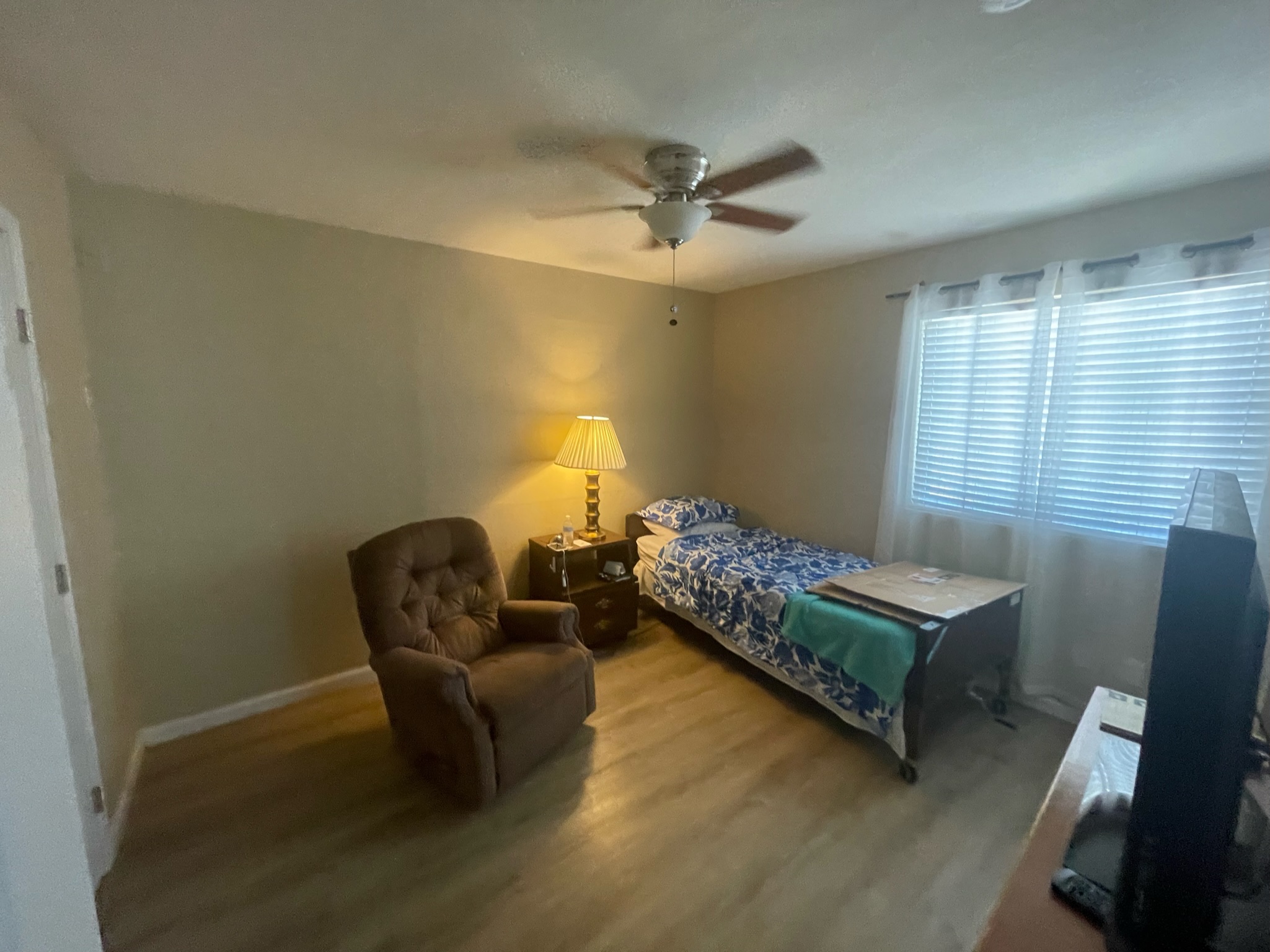 Cozy resident room with a bed and armchair