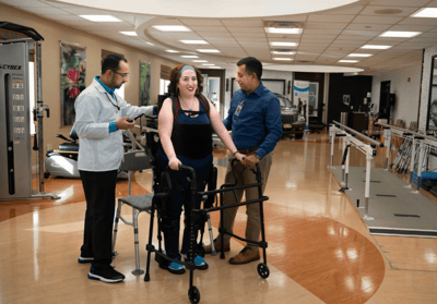 Therapist assisting a resident in a rehabilitation area