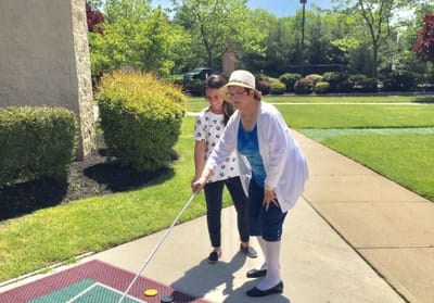 Residents enjoying outdoor mini-golf activity