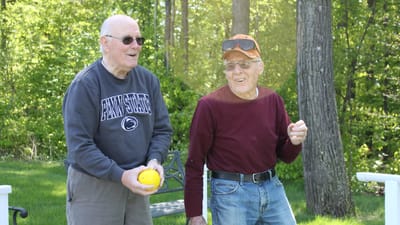 Two residents enjoying outdoor activities in a garden