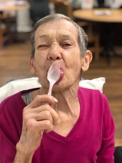 Resident enjoying a treat in a common area