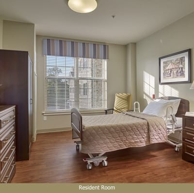 Cozy resident room with a bed and window view