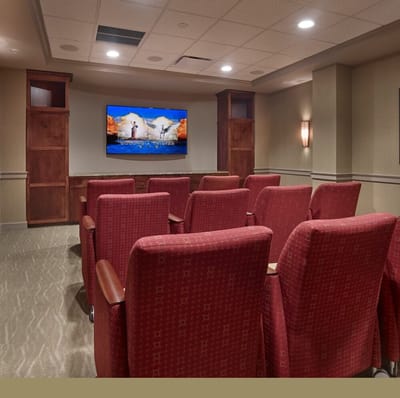 Interior seating area with red chairs and a TV