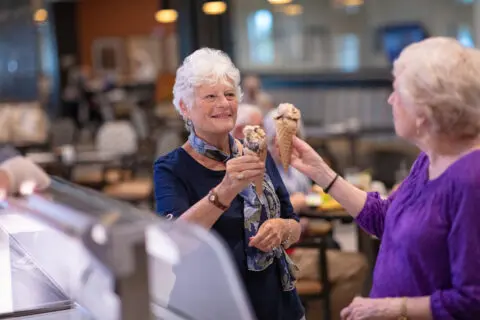 Residents enjoying ice cream cones in a common area