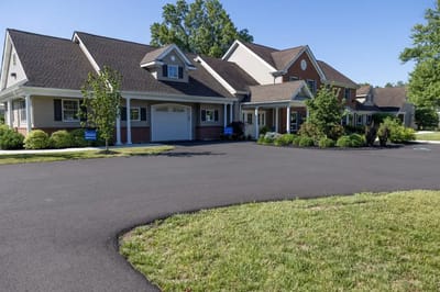 Exterior view of a senior living facility with landscaping