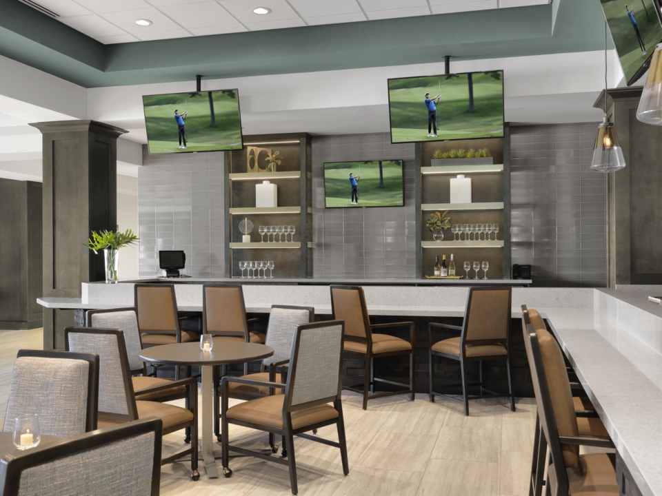 Stylish lounge area with seating and TVs