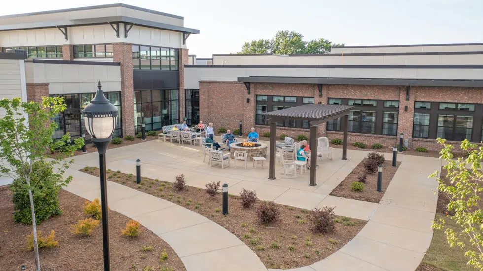 Residents gathered around an outdoor seating area