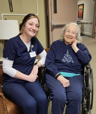 A staff member with a resident in a cozy setting