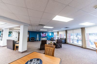 Spacious common area with seating and a television