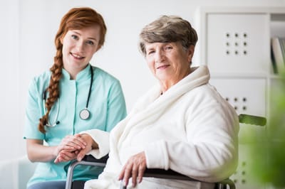 Caregiver with a resident in a bright room