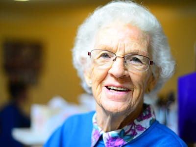 Senior woman smiling in a social setting