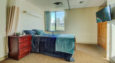 Cozy private resident room with a bed and TV