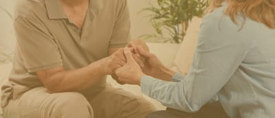 A staff member holding hands with a resident