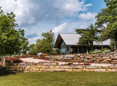 Exterior view of a senior living facility with landscaped gardens