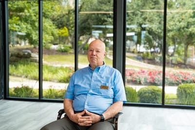 A staff member seated in a bright common area