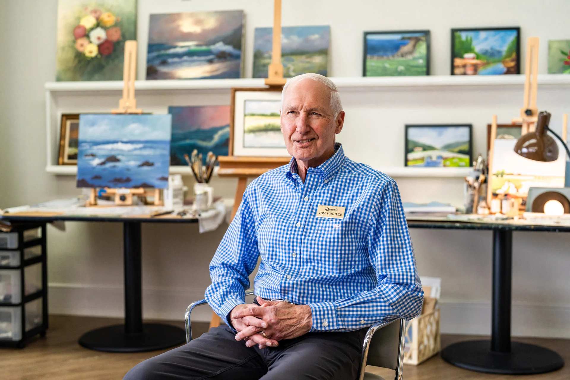 Resident in an art studio surrounded by paintings