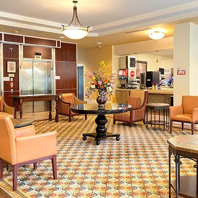 Bright common area with seating and floral centerpieces