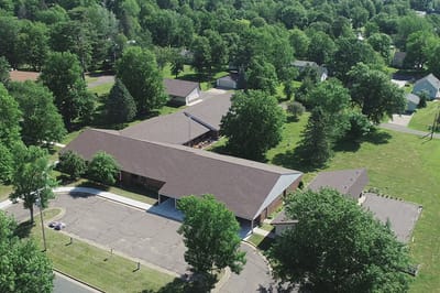 Aerial view of the assisted living facility surrounded by trees