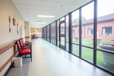 Bright interior hallway with outdoor view and seating