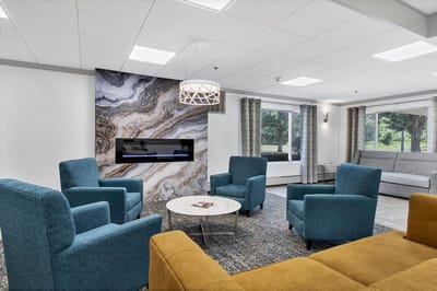 Bright common area with comfortable seating and a fireplace