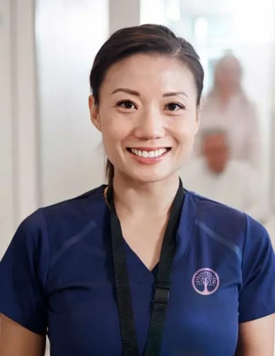 Staff member smiling in a bright common area
