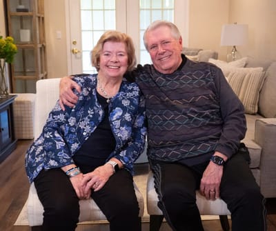 Two residents smiling together in a cozy living room