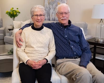 Senior couple posing together in a cozy living area