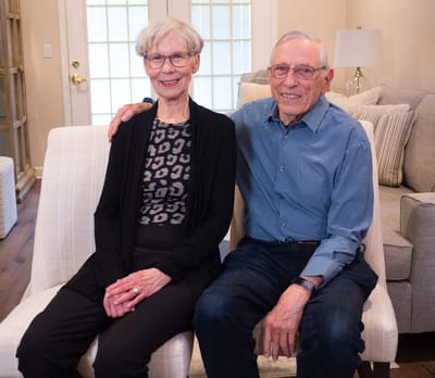 Two residents sitting together in a cozy common area
