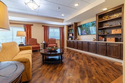 Cozy common area with seating and wooden shelves