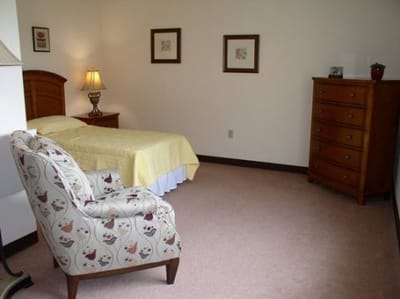 Cozy private resident room with a bed and furniture