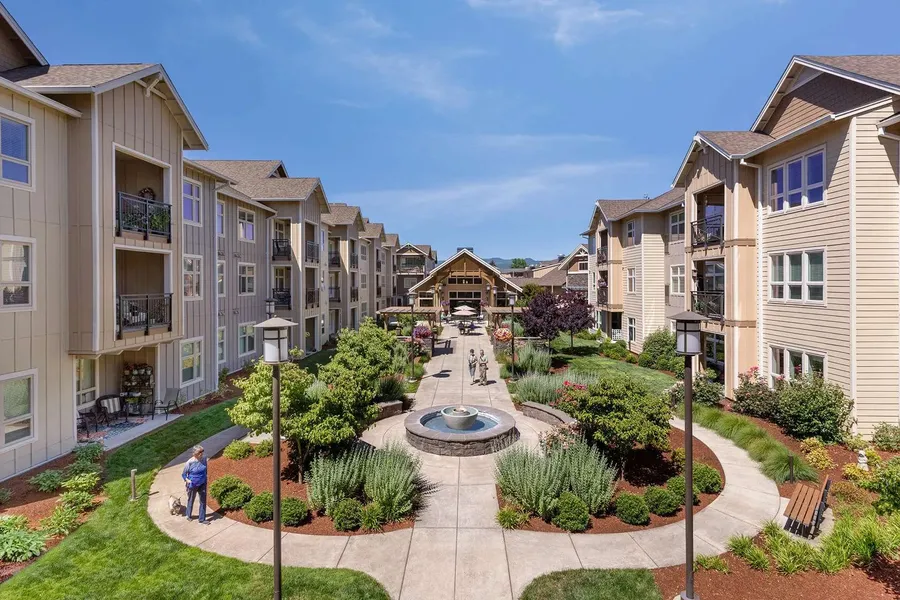 Beautiful garden courtyard with residents enjoying the outdoor space