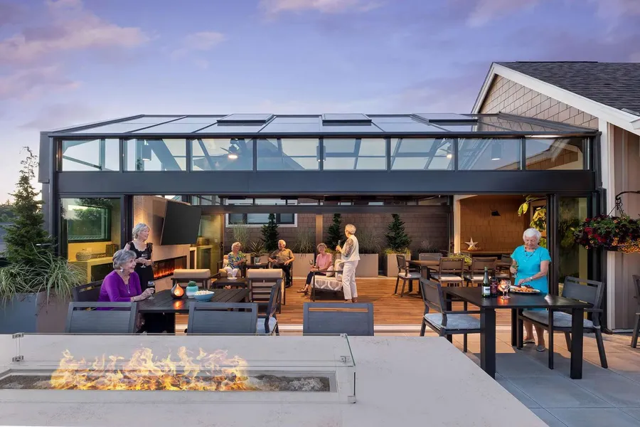 Residents enjoying a social gathering in a sunny patio area