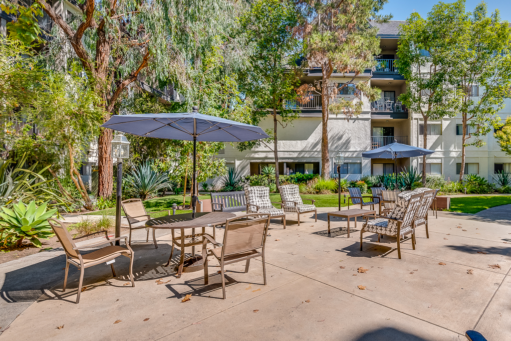 Outdoor seating area with umbrellas in a landscaped garden