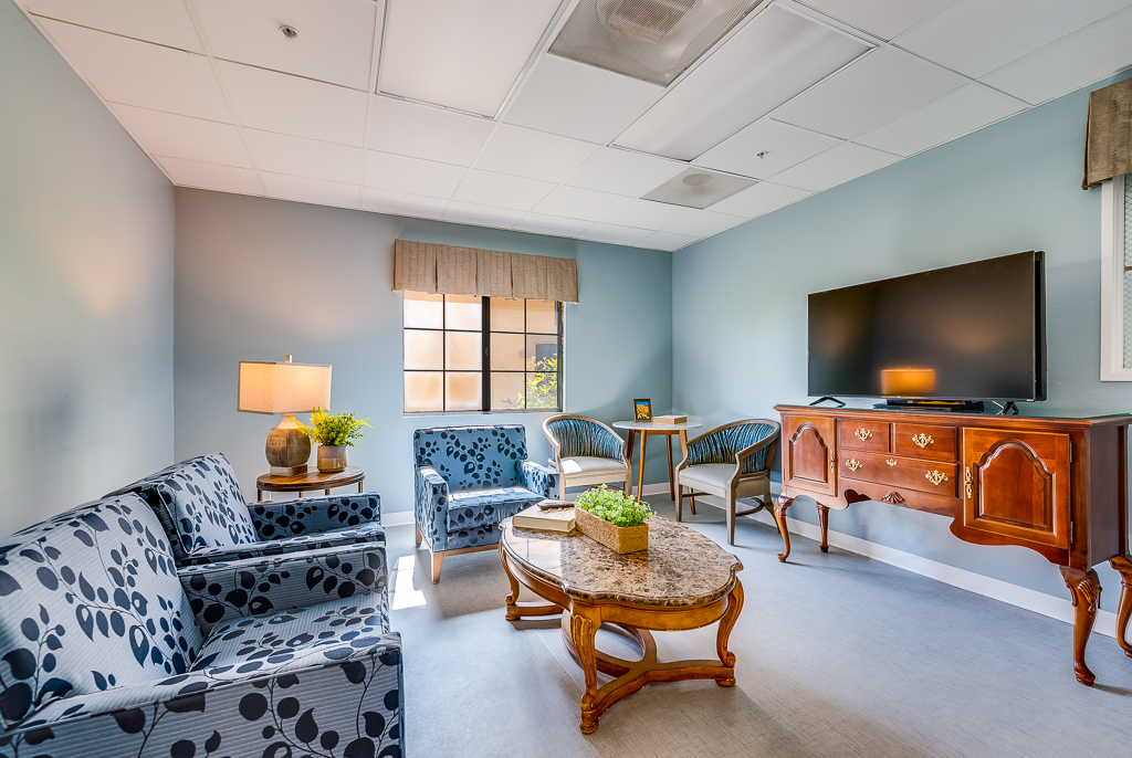 Bright common area with seating and a TV