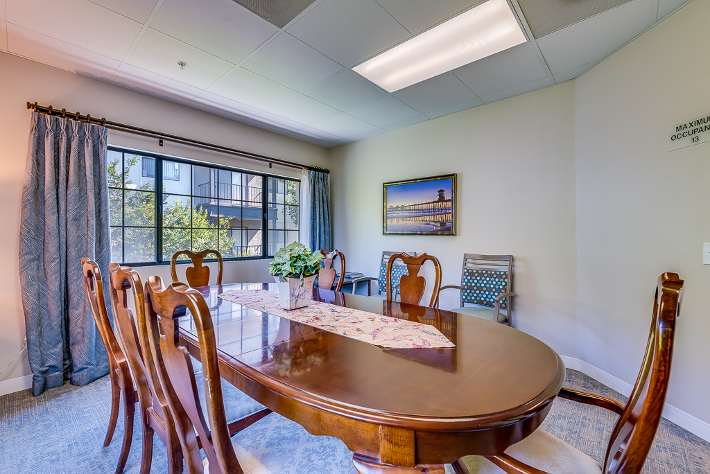 Brightly lit dining area with wooden table and chairs