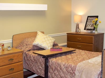 Cozy resident room with a bed and lamp