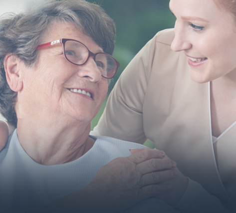 Senior resident smiling with care staff