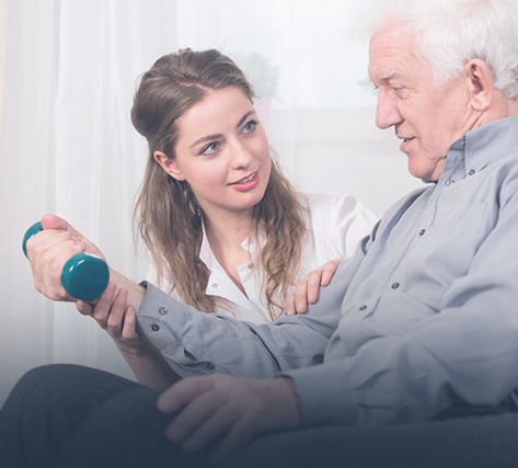 Therapist assisting senior with exercise