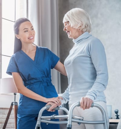 Caregiver assisting a resident in a bright room