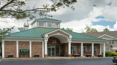Front entrance of a senior living facility with a green roof
