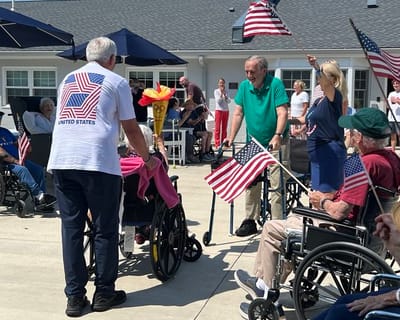 Residents enjoying an outdoor activity with flags