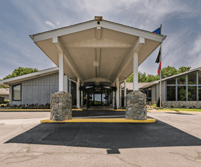Front entrance of a senior living facility with a covered porch