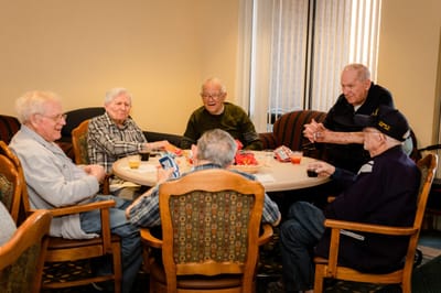 Residents engaged in a group activity around a table