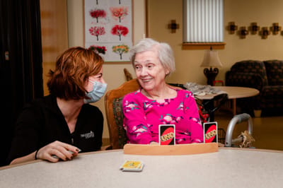 Resident enjoying a game of UNO with staff