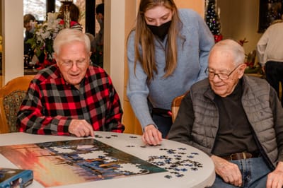 Residents enjoying a puzzle activity at a table