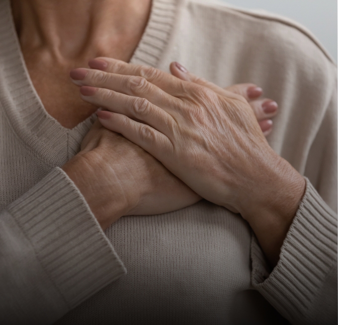 Close-up of hands clasped over a sweater