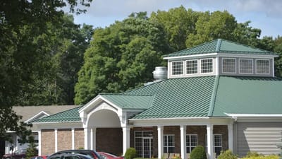 Exterior view of a senior living facility with greenery