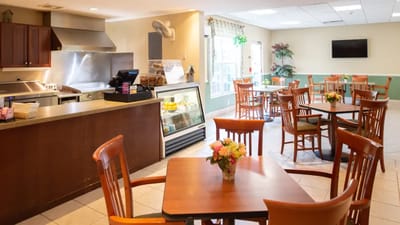 Bright dining area with tables and flowers