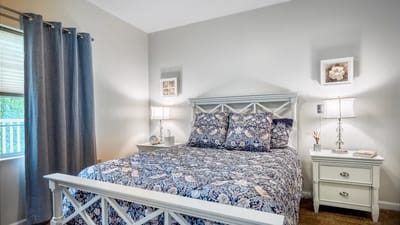 Cozy bedroom with floral bedding and bedside lamps